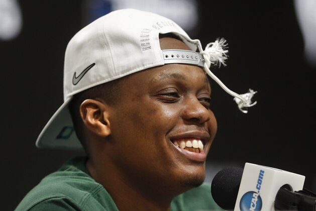 FILE - In this March 31, 2019, file photo, Michigan State guard Cassius Winston (5) smiles while answering questions during a news conference after beating Duke 68-67 in an NCAA men's East Regional final college basketball game, in Washington. Winston has joined a select group of players in program history as an All-America player and Big Ten player of the year. If he can help the Spartans win two more games, he'll join Magic Johnson and Mateen Cleaves as the school's national championship-winning point guards. (AP Photo/ Mark Tenally, File)