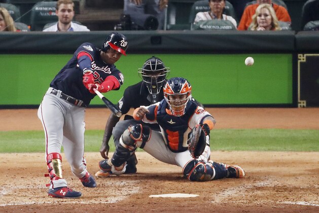 HOUSTON, TEXAS - OCTOBER 22:  Juan Soto #22 of the Washington Nationals hits a two-RBI double against the Houston Astros during the fifth inning in Game One of the 2019 World Series at Minute Maid Park on October 22, 2019 in Houston, Texas. (Photo by Tim Warner/Getty Images)