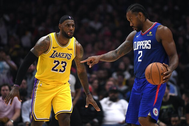 LOS ANGELES, CALIFORNIA - OCTOBER 22:   Kawhi Leonard #2 of the LA Clippers controls possession of the ball in front of LeBron James #23 of the Los Angeles Lakers late in the fourth quarter in a 112-102 Clipper win during the LA Clippers season home opener at Staples Center on October 22, 2019 in Los Angeles, California. (Photo by Harry How/Getty Images)