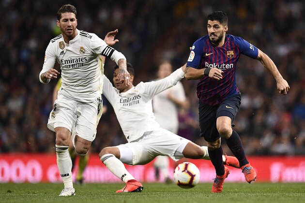Barcelona's Uruguayan forward Luis Suarez (R) vies with Real Madrid's Spanish defender Sergio Ramos (L) as Real Madrid's Brazilian midfielder Casemiro falls down during the Spanish league football match between Real Madrid CF and FC Barcelona at the Santiago Bernabeu stadium in Madrid on March 2, 2019. (Photo by OSCAR DEL POZO / AFP)        (Photo credit should read OSCAR DEL POZO/AFP/Getty Images)
