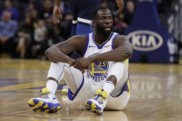 Golden State Warriors' Draymond Green watches from the floor during the first half of the team's NBA preseason basketball game against the Minnesota Timberwolves on Thursday, Oct. 10, 2019, in San Francisco. (AP Photo/Ben Margot)