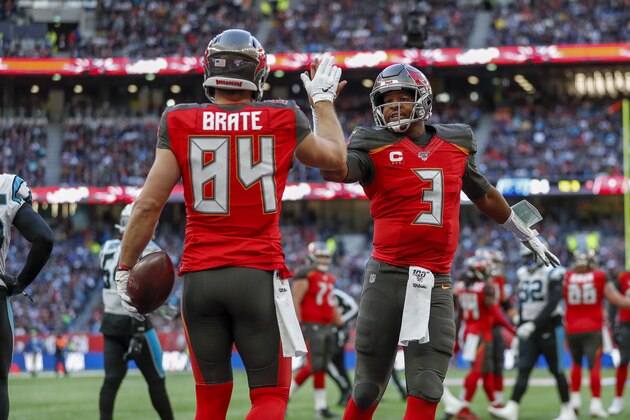 Tampa Bay Buccaneers tight end Cameron Brate (84) celebrates with quarterback Jameis Winston (3) after making a touchdown catch against the Carolina Panthers during the fourth quarter of an NFL football game, Sunday, Oct. 13, 2019, at Tottenham Hotspur Stadium in London. (AP Photo/Alastair Grant)