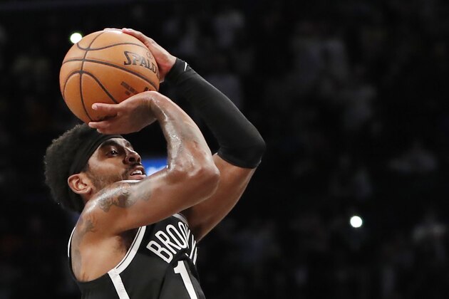 Brooklyn Nets guard Kyrie Irving (11) takes his last shot, which didn't land in the basket, in overtime of an NBA basketball game against the Minnesota Timbers on Wednesday, Oct. 23, 2019, in New York. Irving scored 50 points, but the Timberwolves won 127-126 . (AP Photo/Kathy Willens)