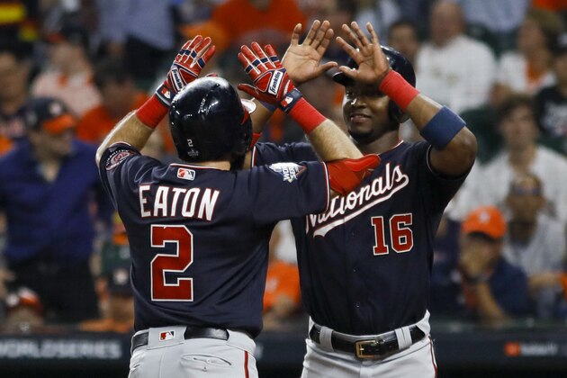 Washington Nationals' Adam Eaton celebrates his two-run home run with Victor Robles during the eighth inning of Game 2 of the baseball World Series against the Washington Nationals Wednesday, Oct. 23, 2019, in Houston. (AP Photo/Matt Slocum)