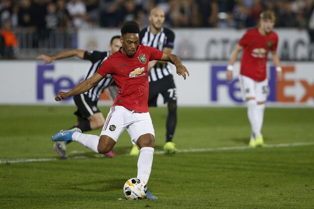 Manchester United's Anthony Martial, center, scores a penalty against Partizan Belgrade during their Europa League group L soccer match at the Partizan stadium in Belgrade, Serbia, Thursday, Oct. 24, 2019. (AP Photo/Marko Drobnjakovic)