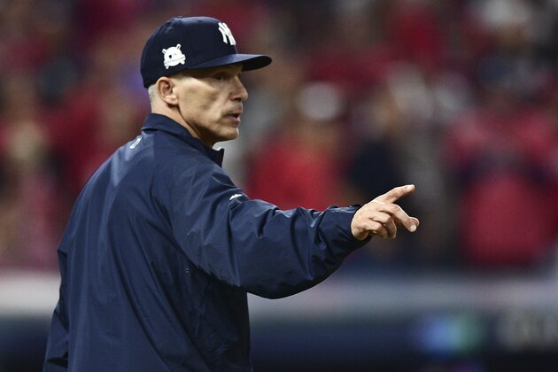 New York Yankees manager Joe Girardi makes a pitching change in the eighth inning of Game 2 of baseball's American League Division Series against the Cleveland Indians, Friday, Oct. 6, 2017, in Cleveland. (AP Photo/David Dermer)