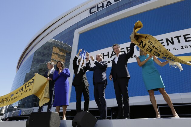 From left, Golden State Warriors COO and President Rick Welts, San Francisco Mayor London Breed, Warriors owners Peter Guber and Joe Lacob, California Gov. Gavin Newsom and JP Morgan Chase CMO Kristin Lemkau take part in the ribbon cutting ceremony of the Chase Center Tuesday, Sept. 3, 2019, in San Francisco. The arena is the new home of the Golden State Warriors NBA basketball team. (AP Photo/Eric Risberg)
