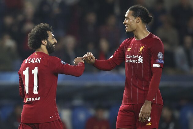 Liverpool's Mohamed Salah, left, is congratulated by Liverpool's Virgil van Dijk after scoring his sides fourth goal during a Champions League group E soccer match between Genk and Liverpool at the KRC Genk Arena in Genk, Belgium, Wednesday, Oct. 23, 2019. (AP Photo/Francisco Seco)