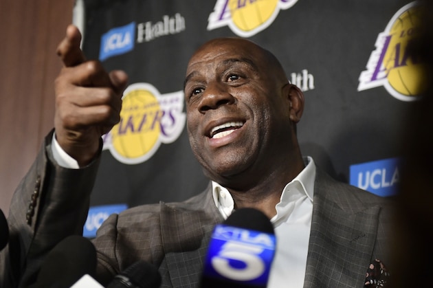FILE - In this April 9, 2019, file photo, Magic Johnson speaks to reporters prior to an NBA basketball game between the Los Angeles Lakers and the Portland Trail Blazer in Los Angeles. Johnson might actually miss the Lakers if he was not always checking up on them. Johnson quit as the team's president of basketball operations at the end of the last season, leaving him out of a gym, but not out of the loop, as Los Angeles opened training camp. (AP Photo/Mark J. Terrill, File)