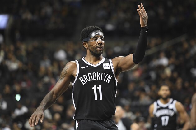 Brooklyn Nets guard Kyrie Irving (11) reacts after making a three-point basket during the third quarter of a preseason NBA basketball game against the Toronto Raptors Friday, Oct. 18, 2019, in New York. (AP Photo/Sarah Stier)