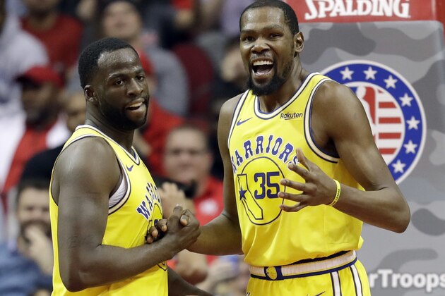 Golden State Warriors' Kevin Durant (35) talks with Draymond Green after a turnover during the second half of an NBA basketball game against the Houston Rockets Thursday, Nov. 15, 2018, in Houston. (AP Photo/David J. Phillip)