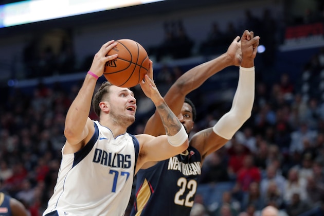 Dallas Mavericks forward Luka Doncic (77) drives to the basket against New Orleans Pelicans forward Derrick Favors (22) in the first half of an NBA basketball game in New Orleans, Friday, Oct. 25, 2019. (AP Photo/Gerald Herbert) Dallas Mavericks forward Luka Doncic (77) drives to the basket against New Orleans Pelicans forward Derrick Favors (22) in the first half of an NBA basketball game in New Orleans, Friday, Oct. 25, 2019. (AP Photo/Gerald Herbert)