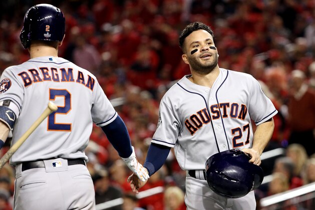 WASHINGTON, DC - OCTOBER 25:  Jose Altuve #27 of the Houston Astros is congratulated by his teammate Alex Bregman #2 after scoring a run against the Washington Nationals during the fifth inning in Game Three of the 2019 World Series at Nationals Park on October 25, 2019 in Washington, DC. (Photo by Patrick Smith/Getty Images)