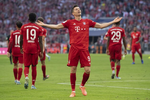 Munich's Robert Lewandowski, center, celebrates after scoring his side second goal during the German Bundesliga soccer match between FC Bayern Munich and 1. FC Union Berlin in Munich, Saturday, Oct. 26, 2019. (Sven Hoppe/dpa via AP)