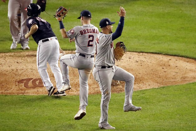 WASHINGTON, DC - OCTOBER 26:  Yuli Gurriel #10 and Alex Bregman #2 of the Houston Astros celebrate their teams 8-1 win against the Washington Nationals in Game Four of the 2019 World Series at Nationals Park on October 26, 2019 in Washington, DC. (Photo by Win McNamee/Getty Images)