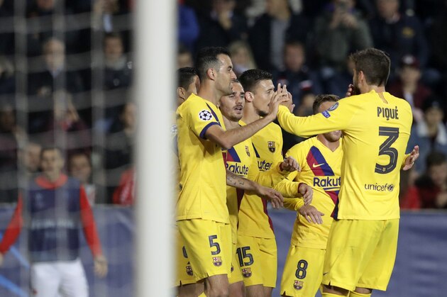 Barcelona players celebrate after Slavia's Peter Olayinka scores an own goal during the Champions League group F soccer match between Slavia Praha and FC Barcelona at the Sinobo stadium in Prague, Czech Republic, Wednesday, Oct. 23, 2019. (AP Photo/Petr David Josek)