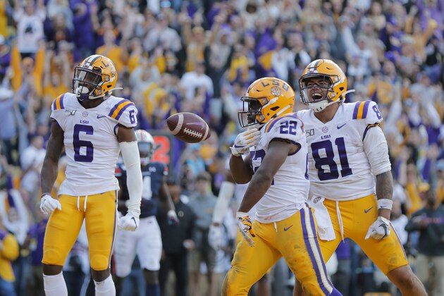 LSU running back Clyde Edwards-Helaire (22) celebrates his touchdown with tight end Thaddeus Moss (81) and wide receiver Terrace Marshall Jr. (6) in the second half of an NCAA college football game against Auburn in Baton Rouge, La., Saturday, Oct. 26, 2019. LSU won 23-20. (AP Photo/Gerald Herbert)