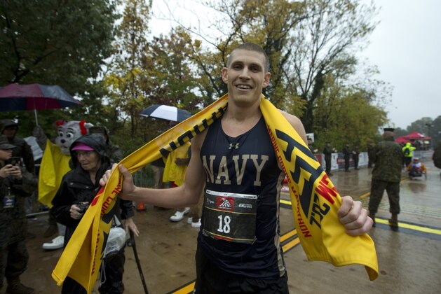Jordan Tropf of Silver Spring crosses the finish line in the first place men's the 44th Marine Corps Marathon, Arlington, Va. Sunday, Oct. 27, 2019. (AP Photo/Jose Luis Magana)