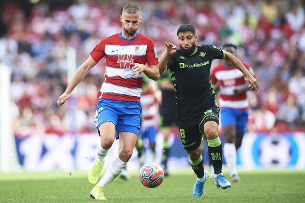 GRANADA, SPAIN - OCTOBER 27: Domingos Duarte of Granada CF is followed by Nabil Fekir of Real Betis Balompie during the Liga match between Granada CF and Real Betis Balompie at  on October 27, 2019 in Granada, Spain. (Photo by Aitor Alcalde Colomer/Getty Images)