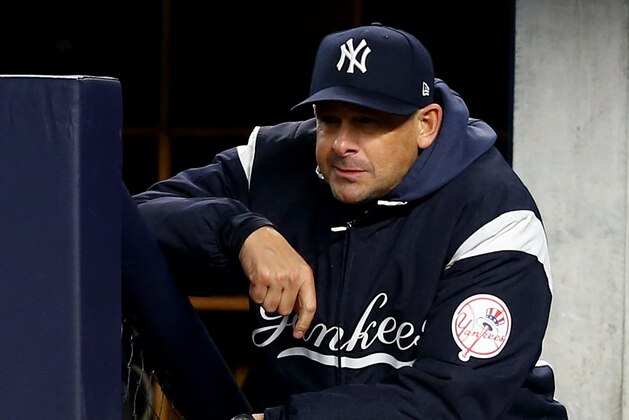 NEW YORK, NEW YORK - OCTOBER 18: Aaron Boone #17 of the New York Yankees looks on from the dugout against the Houston Astros in game five of the American League Championship Series at Yankee Stadium on October 18, 2019 in New York City. (Photo by Mike Stobe/Getty Images)