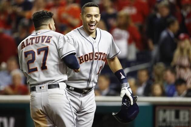 Houston Astros' Carlos Correa celebrates with Jose Altuve (27) after his two-run home run against the Washington Nationals during the fourth inning of Game 5 of the baseball World Series Sunday, Oct. 27, 2019, in Washington. (AP Photo/Patrick Semansky)