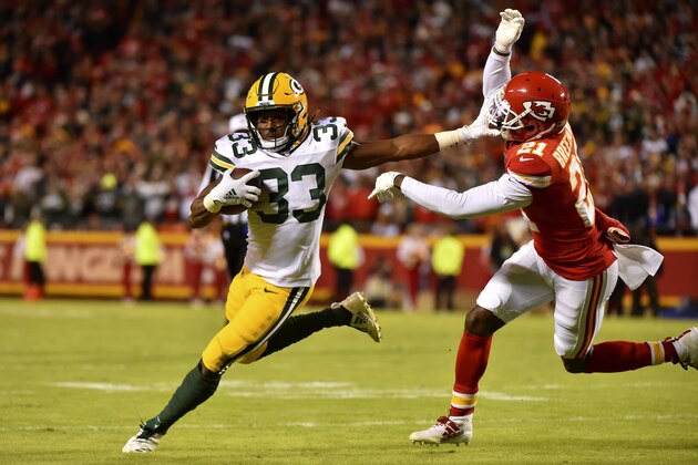 Green Bay Packers running back Aaron Jones (33) carries the ball against Kansas City Chiefs cornerback Bashaud Breeland (21) during the second half of an NFL football game in Kansas City, Mo., Sunday, Oct. 27, 2019. (AP Photo/Ed Zurga)