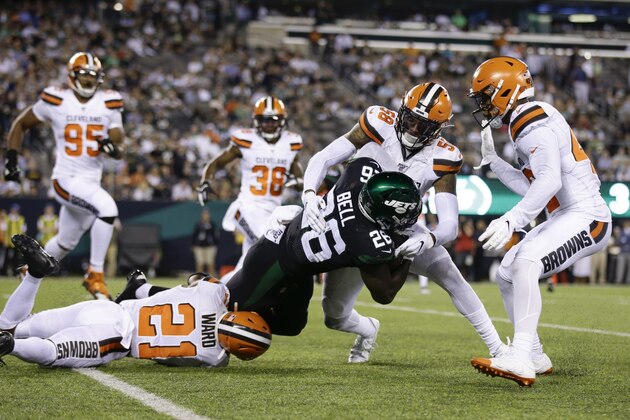 Cleveland Browns' Denzel Ward (21) and Christian Kirksey (58) tackle New York Jets' Le'Veon Bell (26) during the second half of an NFL football game Monday, Sept. 16, 2019, in East Rutherford, N.J. (AP Photo/Adam Hunger)