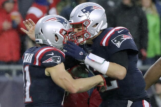 New England Patriots quarterback Tom Brady, right, celebrates his touchdown pass to Julian Edelman, left, in the first half of an NFL football game against the Cleveland Browns, Sunday, Oct. 27, 2019, in Foxborough, Mass. (AP Photo/Elise Amendola)