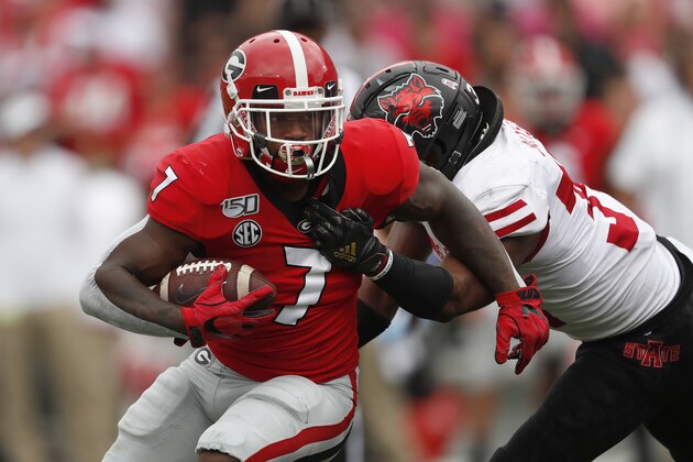 Georgia running back D'Andre Swift (7) is tackled by Arkansas State defensive back Darreon Jackson (34) in the first half of an NCAA college football game Saturday, Sept. 14, 2019, in Athens, Ga. (AP Photo/John Bazemore)