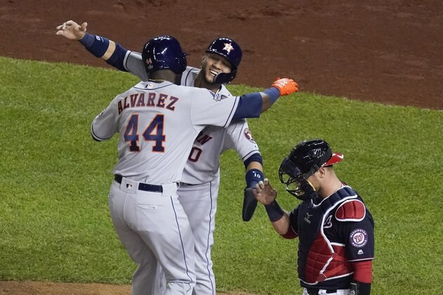 Houston Astros' Yordan Alvarez is congratulated by Yuli Gurriel after hitting a two-run home runn during the second inning of Game 5 of the baseball World Series against the Washington Nationals Sunday, Oct. 27, 2019, in Washington. (AP Photo/Pablo Martinez Monsivais)