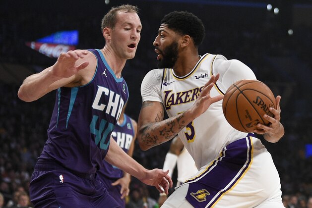 Los Angeles Lakers forward Anthony Davis, right, drives to the basket while Charlotte Hornets forward Cody Zeller defends during the first half of an NBA basketball game in Los Angeles, Sunday, Oct. 27, 2019. (AP Photo/Kelvin Kuo)