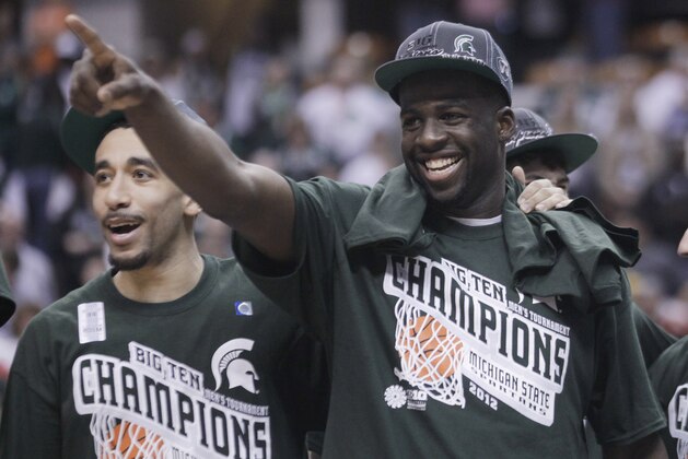 Michigan State forward Draymond Green, right, celebrates after Michigan State defeated Ohio State 68-64 in an NCAA college basketball game in the final of the Big Ten men's tournament, in Indianapolis, Sunday, March 11, 2012. (AP Photo/Michael Conroy)