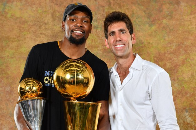 OAKLAND, CA - JUNE 12: Kevin Durant and General Manager Bob Myers of the Golden State Warriors poses for a portrait with the Larry O'Brien Trophy after defeating the Cleveland Cavaliers in Game Five of the 2017 NBA Finals on June 12, 2017 at ORACLE Arena in Oakland, California. NOTE TO USER: User expressly acknowledges and agrees that, by downloading and or using this photograph, User is consenting to the terms and conditions of the Getty Images License Agreement. Mandatory Copyright Notice: Copyright 2017 NBAE (Photo by Jesse D. Garrabrant/NBAE via Getty Images)