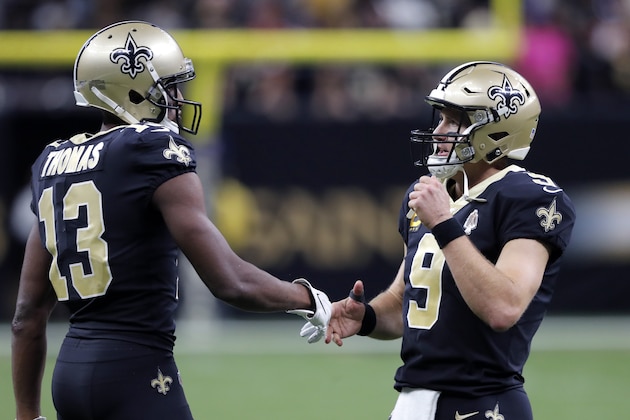 New Orleans Saints quarterback Drew Brees (9) greets New Orleans Saints wide receiver Michael Thomas (13) after a touchdown in the second half of an NFL football game against the Arizona Cardinals in New Orleans, Sunday, Oct. 27, 2019. (AP Photo/Bill Feig)