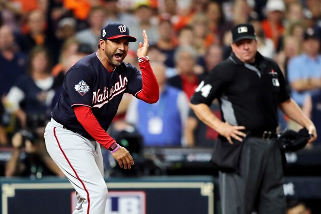 HOUSTON, TEXAS - OCTOBER 29:  Dave Martinez #4 of the Washington Nationals argues a runner interference call with umpire Sam Holbrook #34 during the seventh inning against the Houston Astros in Game Six of the 2019 World Series at Minute Maid Park on October 29, 2019 in Houston, Texas. (Photo by Elsa/Getty Images)
