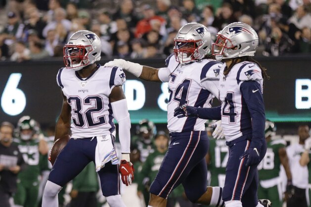 New England Patriots free safety Devin McCourty (32) celebrates with teammates Dont'a Hightower (54) and Stephon Gilmore (24) after intercepting a pass during the first half of an NFL football game against the New York Jets Monday, Oct. 21, 2019, in East Rutherford, N.J. (AP Photo/Adam Hunger)