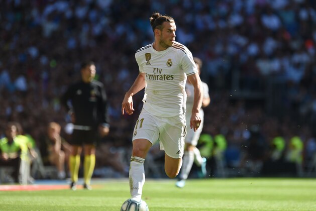 MADRID, SPAIN - OCTOBER 05: Gareth Bale of Real Madrid runs with the ball during the Liga match between Real Madrid CF and Granada CF at Estadio Santiago Bernabeu on October 05, 2019 in Madrid, Spain. (Photo by Denis Doyle/Getty Images)