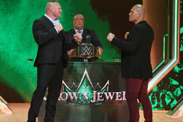 LAS VEGAS, NEVADA - OCTOBER 11:  WWE champion Brock Lesnar (L) and former UFC heavyweight champion Cain Velasquez face off as Lesnar's advocate Paul Heyman (C) looks on during the announcement of their match at a WWE news conference at T-Mobile Arena on October 11, 2019 in Las Vegas, Nevada. Lesnar will face Velasquez and WWE wrestler Braun Strowman will take on heavyweight boxer Tyson Fury at the WWE's Crown Jewel event at Fahd International Stadium in Riyadh, Saudi Arabia on October 31.  (Photo by Ethan Miller/Getty Images)