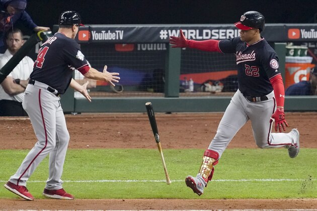 Washington Nationals' Juan Soto tosses his bat to first base coach Tim Bogar after his home run against the Houston Astros during the fifth inning of Game 6 of the baseball World Series Tuesday, Oct. 29, 2019, in Houston. (AP Photo/Eric Gay)