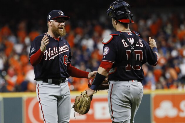 Washington Nationals' Sean Doolittle celebrates with catcher Yan Gomes after Game 6 of the baseball World Series against the Houston Astros Tuesday, Oct. 29, 2019, in Houston. The Nationals won 7-2 to tie the series at 3-3. (AP Photo/Matt Slocum)