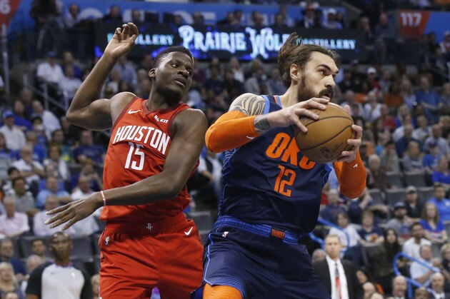 Oklahoma City Thunder center Steven Adams (12) grabs a rebound next to Houston Rockets center Clint Capela (15) during the first half of an NBA basketball game Tuesday, April 9, 2019, in Oklahoma City. (AP Photo/Sue Ogrocki)