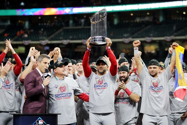 HOUSTON, TEXAS - OCTOBER 30:  Manager Dave Martinez #4 of the Washington Nationals hoists the Commissioners Trophy after defeating the Houston Astros 6-2 in Game Seven to win the 2019 World Series in Game Seven of the 2019 World Series at Minute Maid Park on October 30, 2019 in Houston, Texas. (Photo by Elsa/Getty Images)