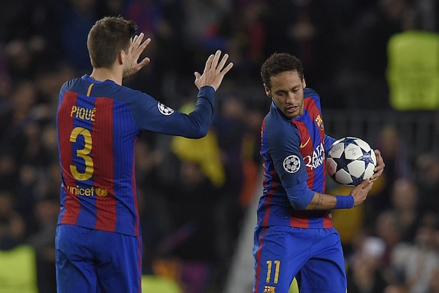 Barcelona's Brazilian forward Neymar (R) and Barcelona's defender Gerard Pique celebrate Paris Saint-Germain's own goal during the UEFA Champions League round of 16 second leg football match FC Barcelona vs Paris Saint-Germain FC at the Camp Nou stadium in Barcelona on March 8, 2017. / AFP PHOTO / LLUIS GENE        (Photo credit should read LLUIS GENE/AFP via Getty Images)