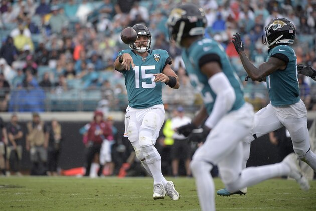 Jacksonville Jaguars quarterback Gardner Minshew (15) throws a pass to wide receiver D.J. Chark, right, during the first half of an NFL football game against the New York Jets Sunday, Oct. 27, 2019, in Jacksonville, Fla. (AP Photo/Phelan M. Ebenhack)