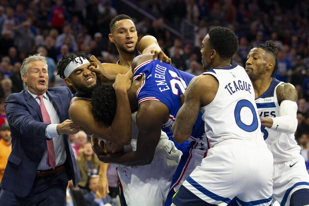 PHILADELPHIA, PA - OCTOBER 30: Joel Embiid #21 of the Philadelphia 76ers gets in a fight with Karl-Anthony Towns #32 of the Minnesota Timberwolves as head coach Brett Brown and Ben Simmons #25 of the Philadelphia 76ers try to break them apart along with Jeff Teague #0 and Robert Covington #33 of the Minnesota Timberwolves in the third quarter at the Wells Fargo Center on October 30, 2019 in Philadelphia, Pennsylvania. NOTE TO USER: User expressly acknowledges and agrees that, by downloading and or using this photograph, User is consenting to the terms and conditions of the Getty Images License Agreement. (Photo by Mitchell Leff/Getty Images)