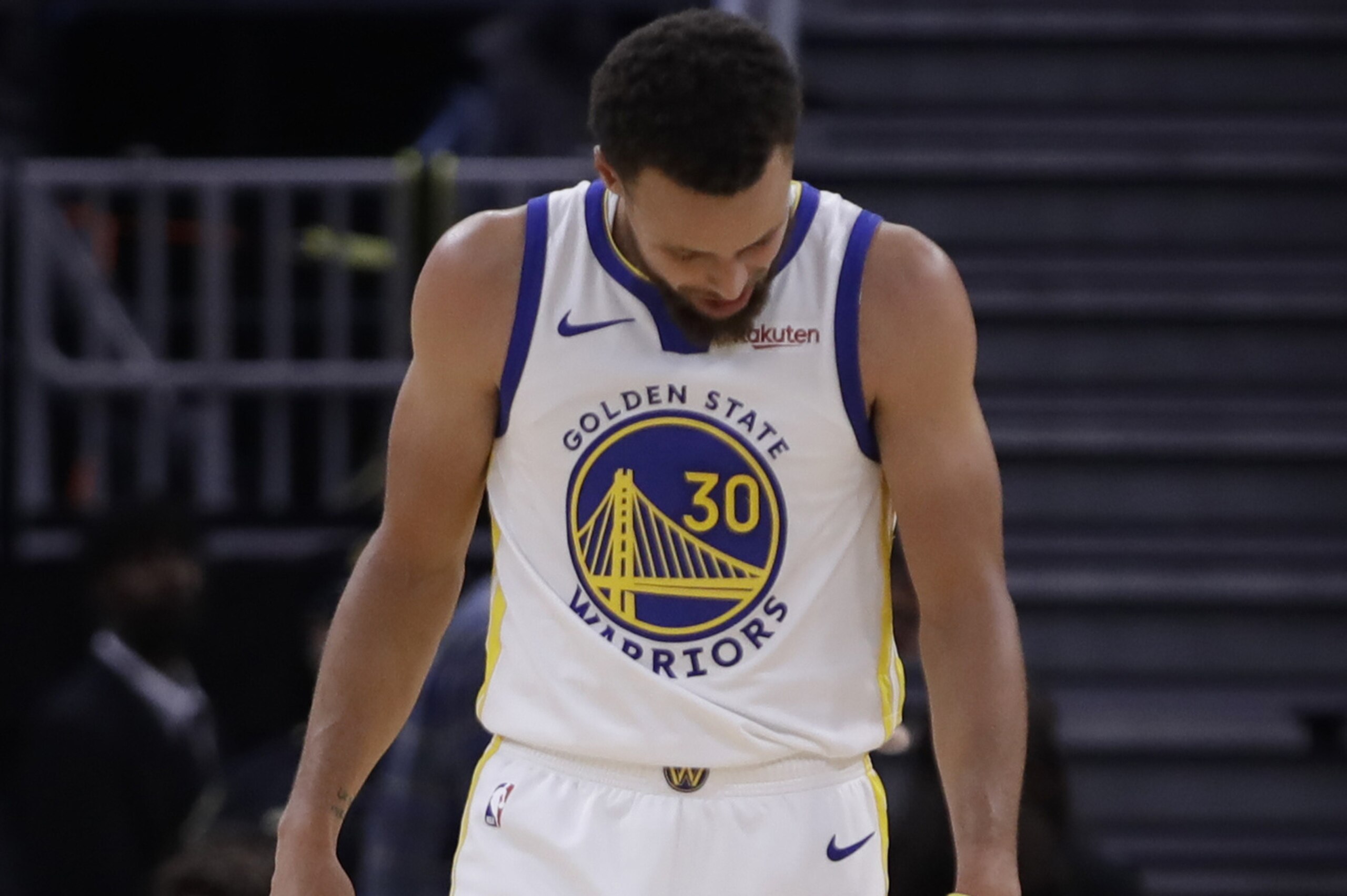 Golden State Warriors' Stephen Curry looks at his left hand after Phoenix Suns' Aron Baynes fell onto him during the second half of an NBA basketball game Wednesday, Oct. 30, 2019, in San Francisco. Curry left the game. (AP Photo/Ben Margot)