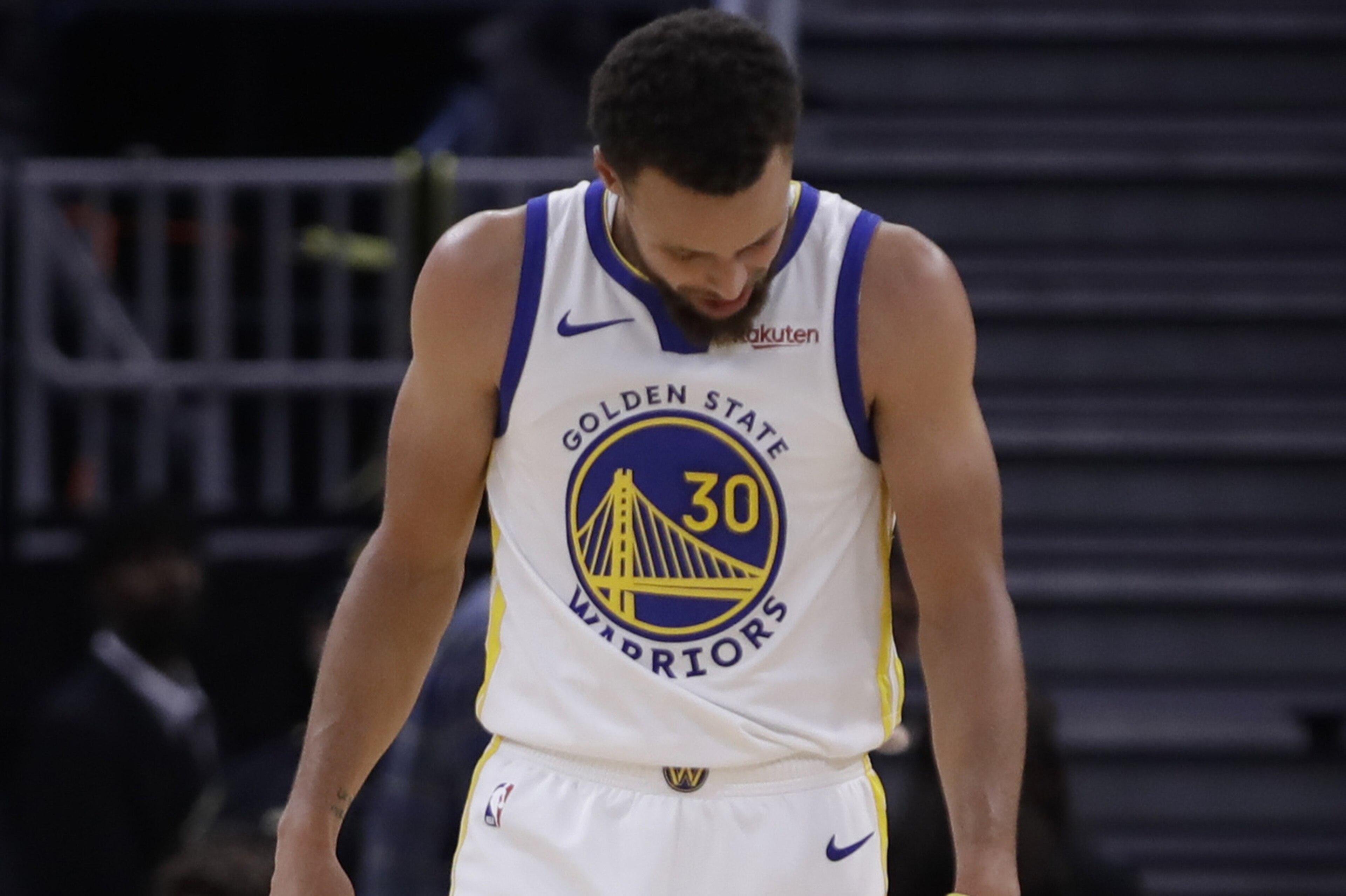 Golden State Warriors' Stephen Curry looks at his left hand after Phoenix Suns' Aron Baynes fell onto him during the second half of an NBA basketball game Wednesday, Oct. 30, 2019, in San Francisco. Curry left the game. (AP Photo/Ben Margot)