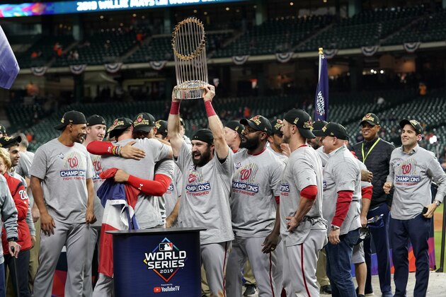 The Washington Nationals celebrate with the trophy after Game 7 of the baseball World Series against the Houston Astros Wednesday, Oct. 30, 2019, in Houston. The Nationals won 6-2 to win the series. (AP Photo/David J. Phillip)