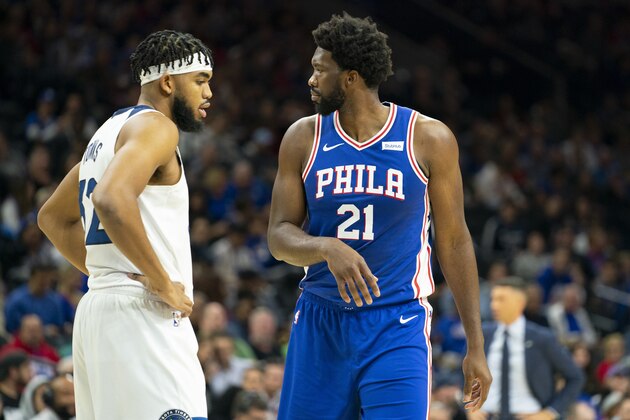 PHILADELPHIA, PA - OCTOBER 30: Karl-Anthony Towns #32 of the Minnesota Timberwolves and Joel Embiid #21 of the Philadelphia 76ers look on in the first quarter at the Wells Fargo Center on October 30, 2019 in Philadelphia, Pennsylvania. The 76ers defeated the Wolves 117-95. NOTE TO USER: User expressly acknowledges and agrees that, by downloading and or using this photograph, User is consenting to the terms and conditions of the Getty Images License Agreement. (Photo by Mitchell Leff/Getty Images)