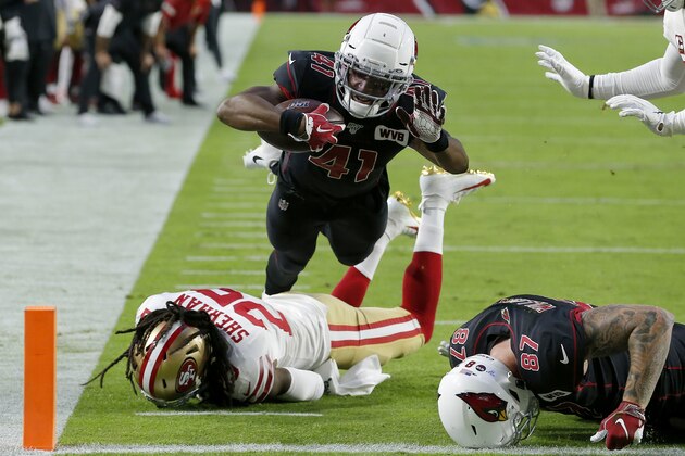 Arizona Cardinals Kenyan Drake (41) scores a touchdown as San Francisco 49ers cornerback Richard Sherman during the first half of an NFL football game, Thursday, Oct. 31, 2019, in Glendale, Ariz. (AP Photo/Rick Scuteri)